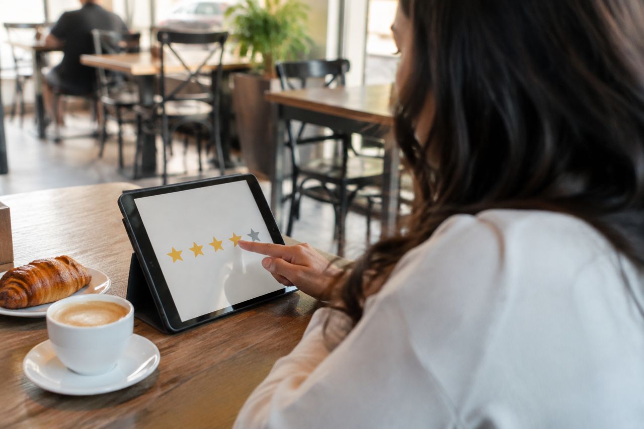 Customer leaving a review on a tablet