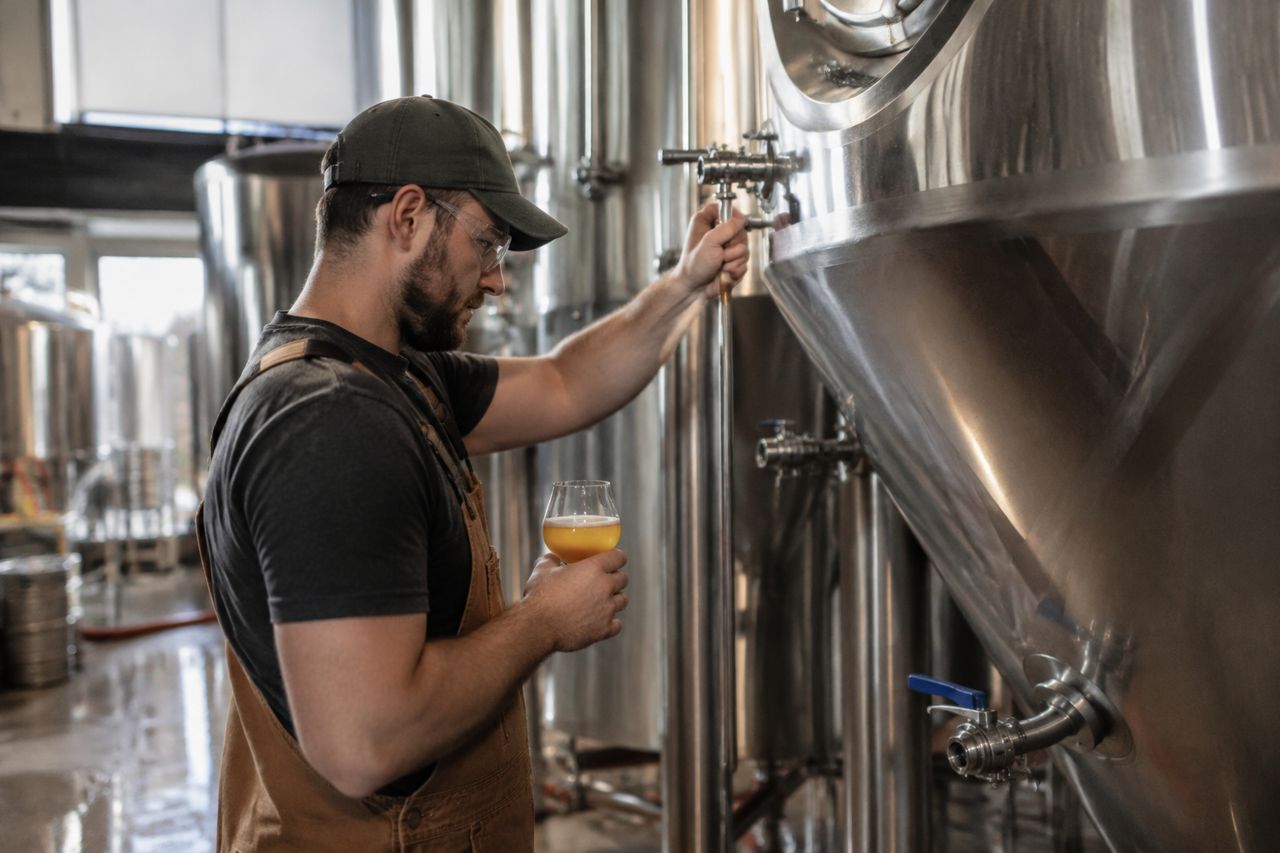 Brewer checking beer tanks