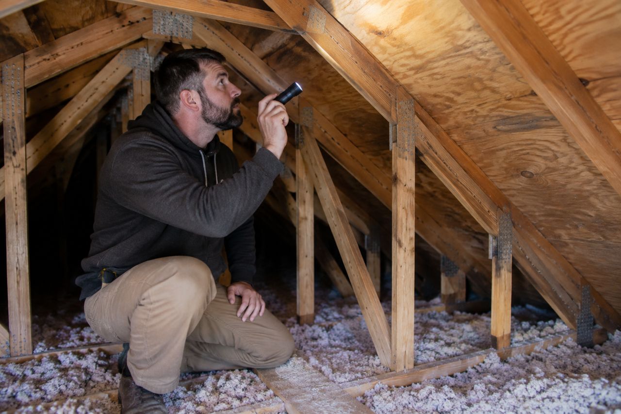 Home inspector in an attic